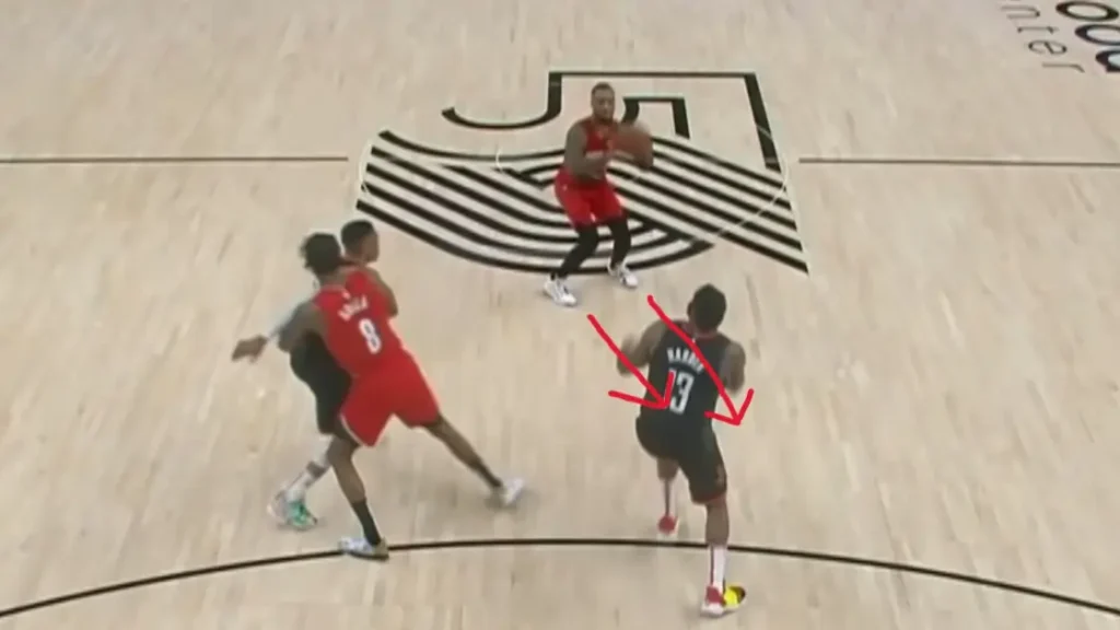Image showing the lower body of a basketball player during a jump shot, with feet positioned pointing towards 10 to 11 o'clock, demonstrating the optimal toe alignment for shooting, similar to the technique used by professional basketball players like Damian Lillard.